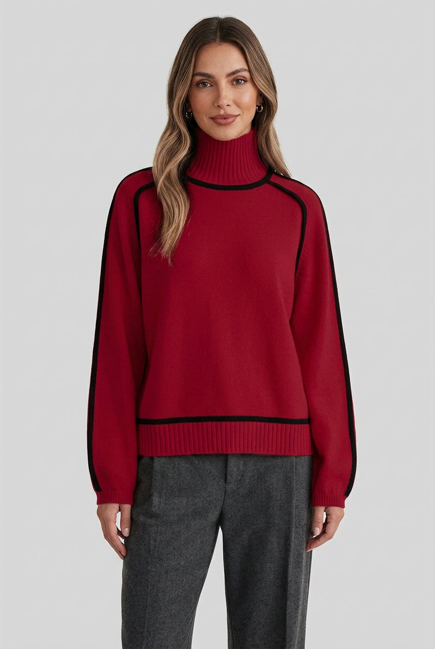 Red sweater with black accents worn by a person against a neutral background