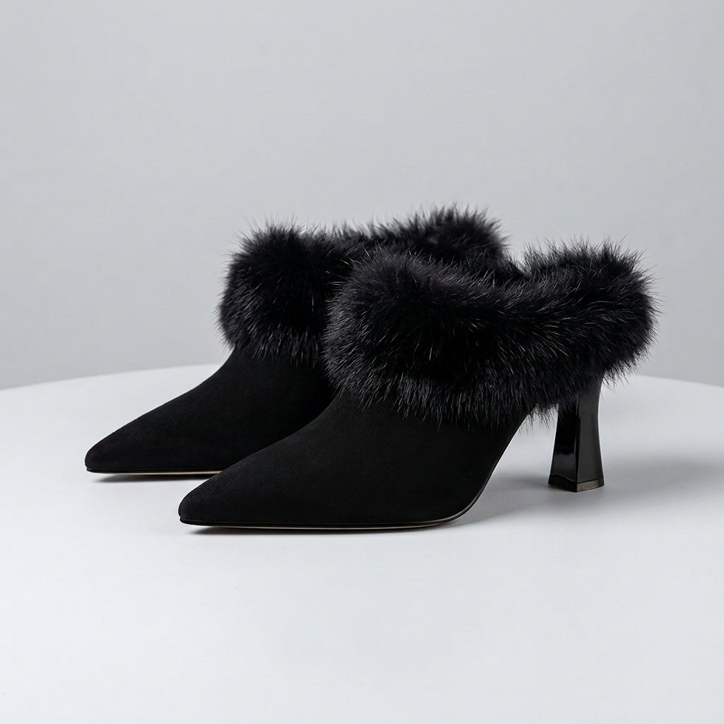 Black high-heeled shoes with fur trim on a brown background