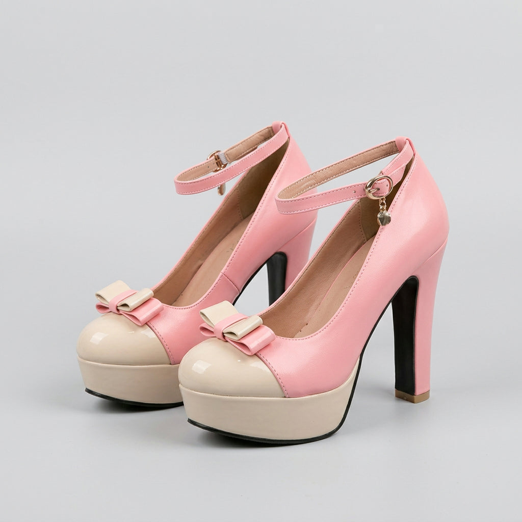 A pair of pink and cream platform high heels with clear plastic straps, displayed on a beige tufted sofa with a blurred background of a plant and window blinds.
